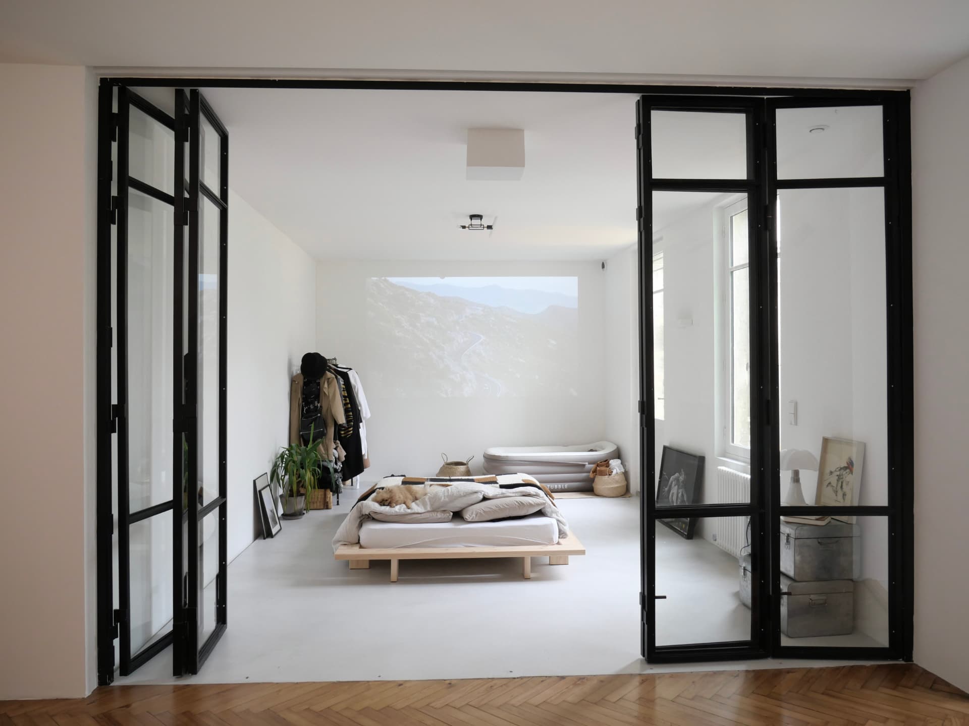 Verrière intérieure noire séparant un salon et une chambre